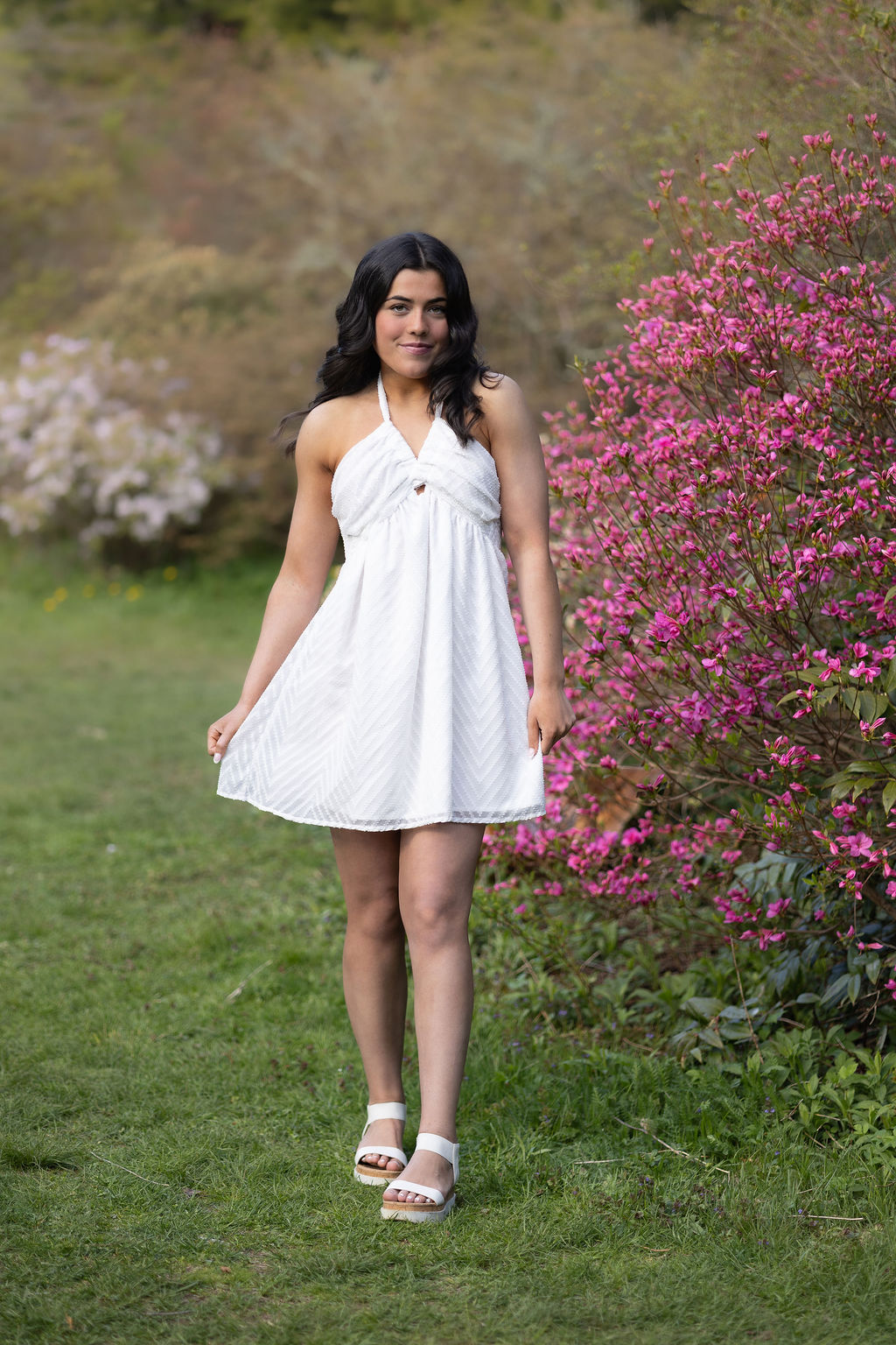 woman-in-white-dress-standing-beside-pink-flowers