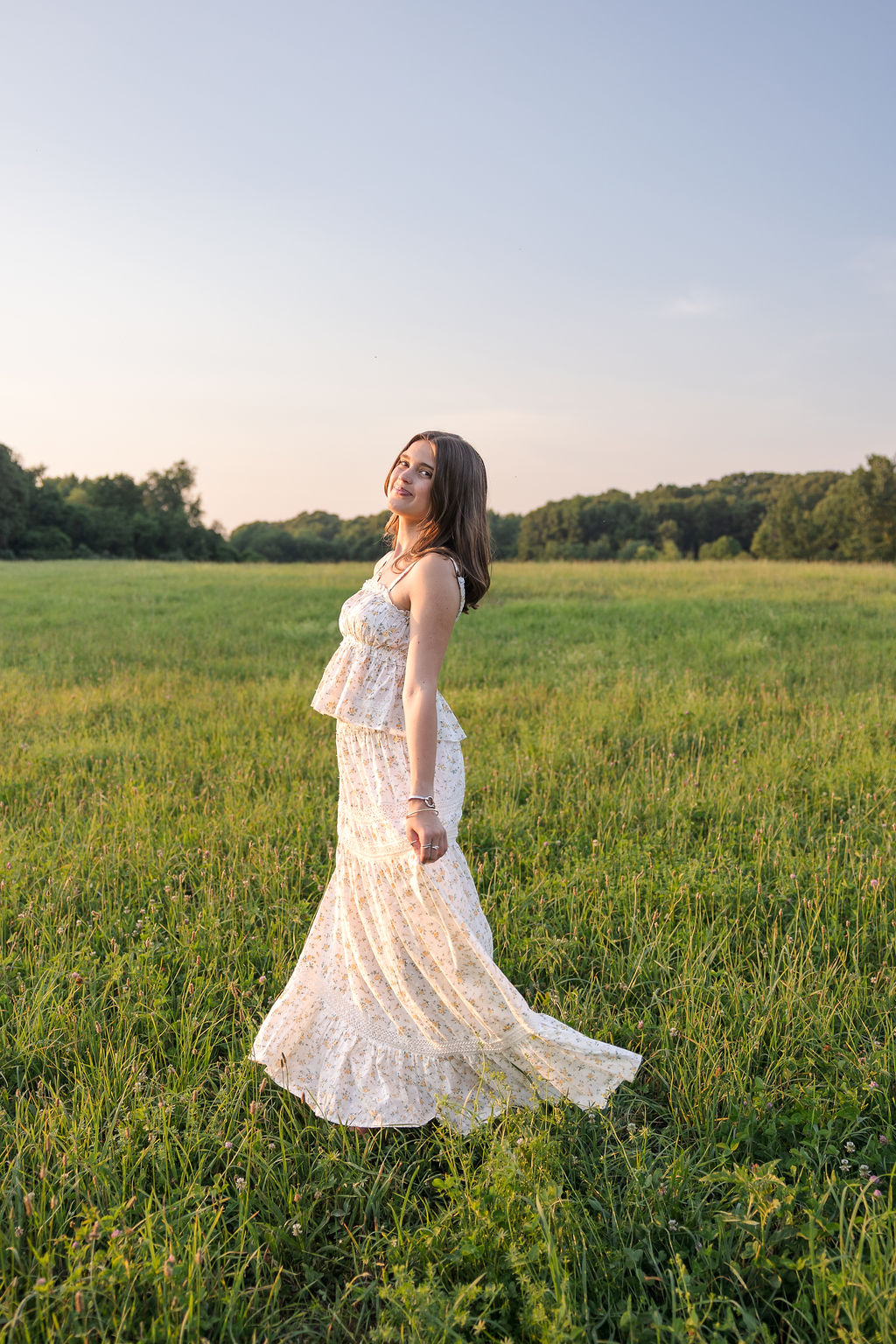 woman-in-white-floral-dress-posing-in-green-meadow